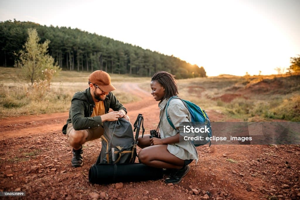 Couple arrange their hiking equipment.